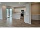 Open concept kitchen with white cabinetry, stainless appliances, and wood look tile flooring at 3390 S 180Th Ln, Goodyear, AZ 85338