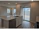 Bright and open concept kitchen showcasing a center island, stainless steel appliances and a backyard view at 3390 S 180Th Ln, Goodyear, AZ 85338