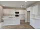 Bright open kitchen with white cabinets, a center island with a sink, and stainless steel appliances at 3390 S 180Th Ln, Goodyear, AZ 85338