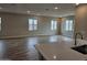 Open concept kitchen flows into a large living room with many windows and wood look tile flooring at 3390 S 180Th Ln, Goodyear, AZ 85338
