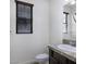 Bright bathroom featuring a single sink vanity with neutral countertops and a window for natural light at 3558 E Windsor Dr, Gilbert, AZ 85296