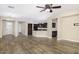Open-concept living room features wood floors, neutral walls, and seamless flow into the kitchen at 3558 E Windsor Dr, Gilbert, AZ 85296