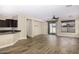 Sunlit living space featuring hardwood floors, modern light fixtures, and sliding glass doors to the patio at 3558 E Windsor Dr, Gilbert, AZ 85296