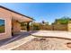 A backyard featuring a covered patio, desert landscaping, and a small fire pit at 3608 W Morelos St, Chandler, AZ 85226