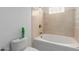 Cozy bathroom featuring a classic tub and tile shower, paired with a neutral-toned wall for a serene feel at 3608 W Morelos St, Chandler, AZ 85226