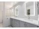 Well-lit bathroom featuring dual sinks, gray cabinetry, and quartz countertops plus modern mirror lighting at 3608 W Morelos St, Chandler, AZ 85226