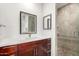 Bathroom with cherry vanity, quartz countertop, modern fixtures, and tile shower with glass door at 3608 W Morelos St, Chandler, AZ 85226