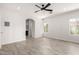 Spacious bedroom with stylish wood-look floors, neutral walls, ceiling fan, and natural light from large windows at 3608 W Morelos St, Chandler, AZ 85226
