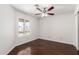 Bright bedroom featuring hardwood floors, a ceiling fan, and a window to the backyard at 3608 W Morelos St, Chandler, AZ 85226