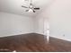 Open primary bedroom features hardwood floors, a ceiling fan, natural light, and a connected ensuite at 3608 W Morelos St, Chandler, AZ 85226