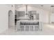 Modern kitchen with gray cabinets, stainless steel appliances, large island with seating, and sleek tile flooring at 3608 W Morelos St, Chandler, AZ 85226