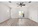 Open living area with wood-look floors, ceiling fan, neutral walls, and French doors leading to patio at 3608 W Morelos St, Chandler, AZ 85226