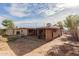 View of backyard featuring patio roof and exposed exterior renovation materials at 3622 W Sunland Ave, Phoenix, AZ 85041