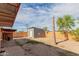 View of spacious backyard featuring a shed and partially completed fence at 3622 W Sunland Ave, Phoenix, AZ 85041