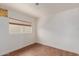 This light and bright bedroom offers new flooring and a large window at 3622 W Sunland Ave, Phoenix, AZ 85041