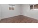 A bright room with new flooring and lots of light through two windows at 3622 W Sunland Ave, Phoenix, AZ 85041