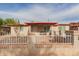View of the front of the home showing the entry, small porch, and white iron fence with brick at 3622 W Sunland Ave, Phoenix, AZ 85041