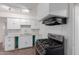 Modern kitchen with stainless steel stove, white cabinets, and stylish marble backsplash at 3622 W Sunland Ave, Phoenix, AZ 85041