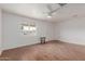 Living room with hardwood-style floors, a ceiling fan, a bright window, and all-white walls at 3622 W Sunland Ave, Phoenix, AZ 85041