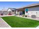 Well-maintained backyard featuring artificial grass, gravel landscaping, and a covered patio for relaxation at 37008 N Aleutian Dr, San Tan Valley, AZ 85143