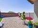Expansive backyard with decorative plants and rock landscaping offers serene outdoor living at 37008 N Aleutian Dr, San Tan Valley, AZ 85143