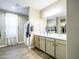 Elegant bathroom featuring a double sink vanity, walk-in shower, and wood-look tile flooring at 37008 N Aleutian Dr, San Tan Valley, AZ 85143