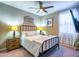 Cozy bedroom featuring a metal-frame bed, soft lighting from bedside lamps, and neutral decor at 37008 N Aleutian Dr, San Tan Valley, AZ 85143