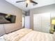 Comfortable bedroom showcasing a ceiling fan, closet with sliding doors, and a TV at 37008 N Aleutian Dr, San Tan Valley, AZ 85143
