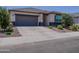 Charming single-story home showcasing desert landscaping and a two-car garage at 37008 N Aleutian Dr, San Tan Valley, AZ 85143
