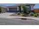 Charming single-story home showcasing desert landscaping and a two-car garage at 37008 N Aleutian Dr, San Tan Valley, AZ 85143