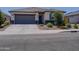 Charming single-story home with a well-manicured lawn and a welcoming blue front door at 37008 N Aleutian Dr, San Tan Valley, AZ 85143