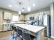 A modern kitchen with stainless steel appliances, a large island, and stylish pendant lighting at 37008 N Aleutian Dr, San Tan Valley, AZ 85143