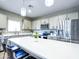 Stylish kitchen with an island, stainless steel appliances, and elegant pendant lighting above breakfast bar at 37008 N Aleutian Dr, San Tan Valley, AZ 85143