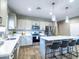Open kitchen featuring stainless steel appliances, neutral-toned cabinetry, and a spacious central island at 37008 N Aleutian Dr, San Tan Valley, AZ 85143