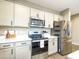 Contemporary kitchen boasts stainless steel appliances, white quartz countertops, and neutral-toned cabinetry at 37008 N Aleutian Dr, San Tan Valley, AZ 85143