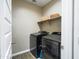 Practical laundry room with front-load washer and dryer and shelving at 37008 N Aleutian Dr, San Tan Valley, AZ 85143