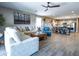 Spacious living room showcasing an open floor plan, stylish furnishings, and seamless flow into the dining area at 37008 N Aleutian Dr, San Tan Valley, AZ 85143