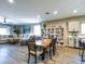 Open-concept living and dining area with tile flooring and a view into the modern kitchen at 37008 N Aleutian Dr, San Tan Valley, AZ 85143