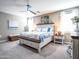 A well-lit main bedroom features an accent wall, a ceiling fan, and soft, neutral colors at 37008 N Aleutian Dr, San Tan Valley, AZ 85143