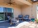Covered patio with outdoor seating, ceiling fan, and landscaped views, ideal for entertaining and relaxation at 37008 N Aleutian Dr, San Tan Valley, AZ 85143