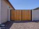 Sturdy wooden side gate set against a brick wall, offering both privacy and curb appeal at 37008 N Aleutian Dr, San Tan Valley, AZ 85143