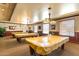 Community billiard room featuring three billiard tables, overhead lighting, and comfortable seating areas at 3755 E Hazeltine Way, Chandler, AZ 85249