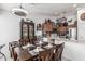 Open dining area with dark wood table set for dinner, adjacent to a modern kitchen at 3755 E Hazeltine Way, Chandler, AZ 85249