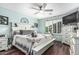 Comfortable main bedroom featuring a ceiling fan, shutters, and en-suite bathroom at 3755 E Hazeltine Way, Chandler, AZ 85249