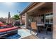 Relaxing covered patio with plush lounge chairs, perfect for outdoor living and entertaining at 3755 E Hazeltine Way, Chandler, AZ 85249