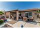 Covered outdoor patio featuring stylish seating areas with views of the landscaped backyard at 3755 E Hazeltine Way, Chandler, AZ 85249