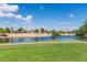 Scenic view of a tranquil pond surrounded by lush green grass and well-maintained landscaping at 3755 E Hazeltine Way, Chandler, AZ 85249