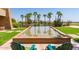Outdoor water feature surrounded by manicured landscaping and palm trees at 3755 E Hazeltine Way, Chandler, AZ 85249