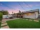 Expansive backyard with artificial turf, patio, outdoor seating, and a beautiful pool area, perfect for entertaining at 4613 S Rita Ln, Tempe, AZ 85282