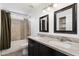 Well-lit bathroom featuring double sinks, granite countertops, and tiled shower-bathtub combo at 4613 S Rita Ln, Tempe, AZ 85282
